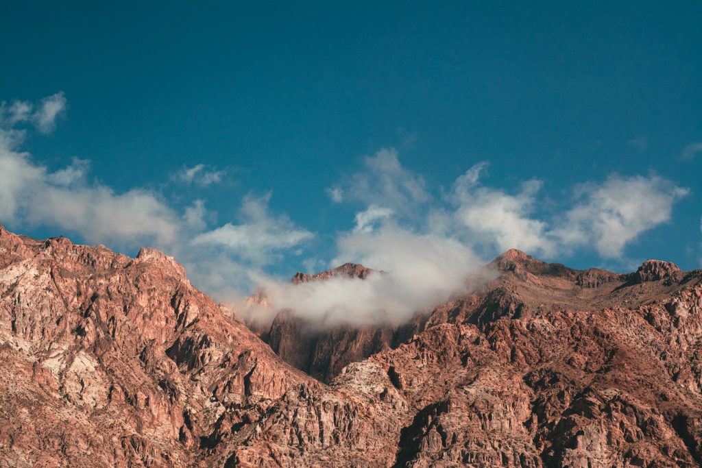 brown rocky mountain under blue sky during daytime