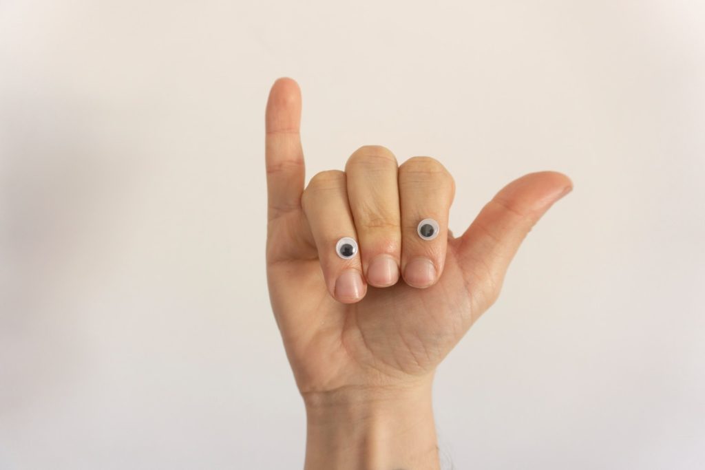 person with white manicure on right hand